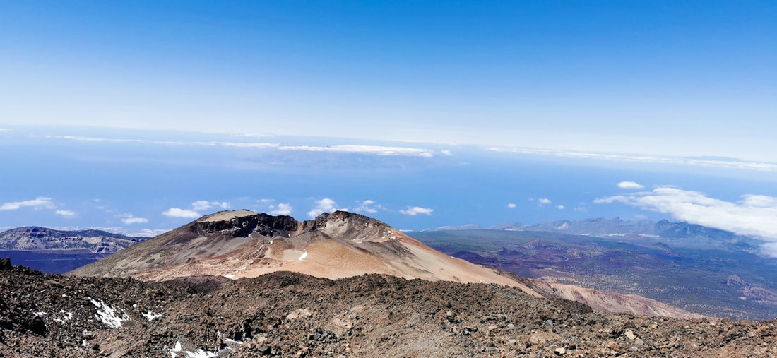 A view of a mountain range from the top of a hill