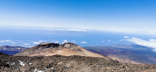 A view of a mountain range from the top of a hill