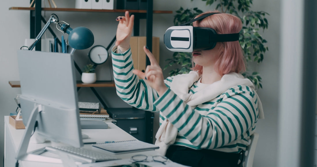 A woman using a virtual reality headset at a desk