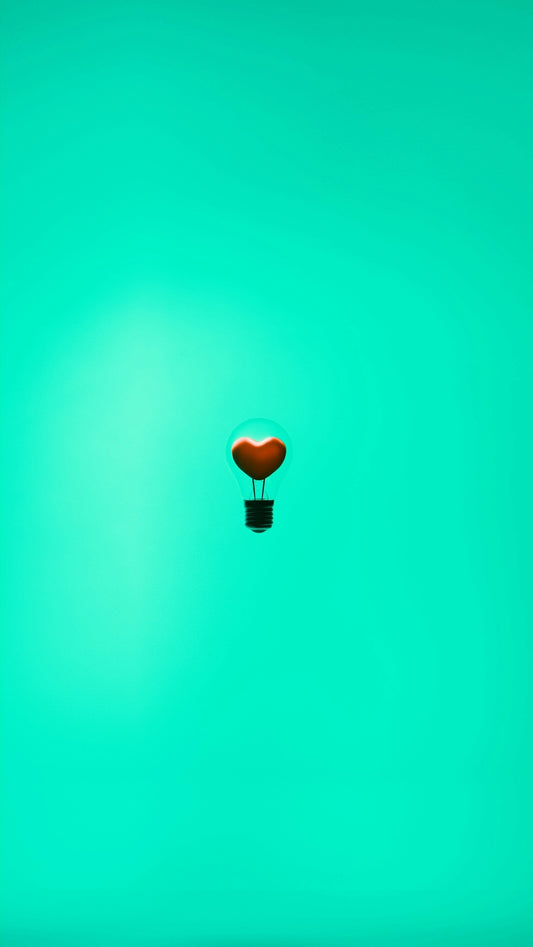 A heart-shaped light bulb floats in the air.